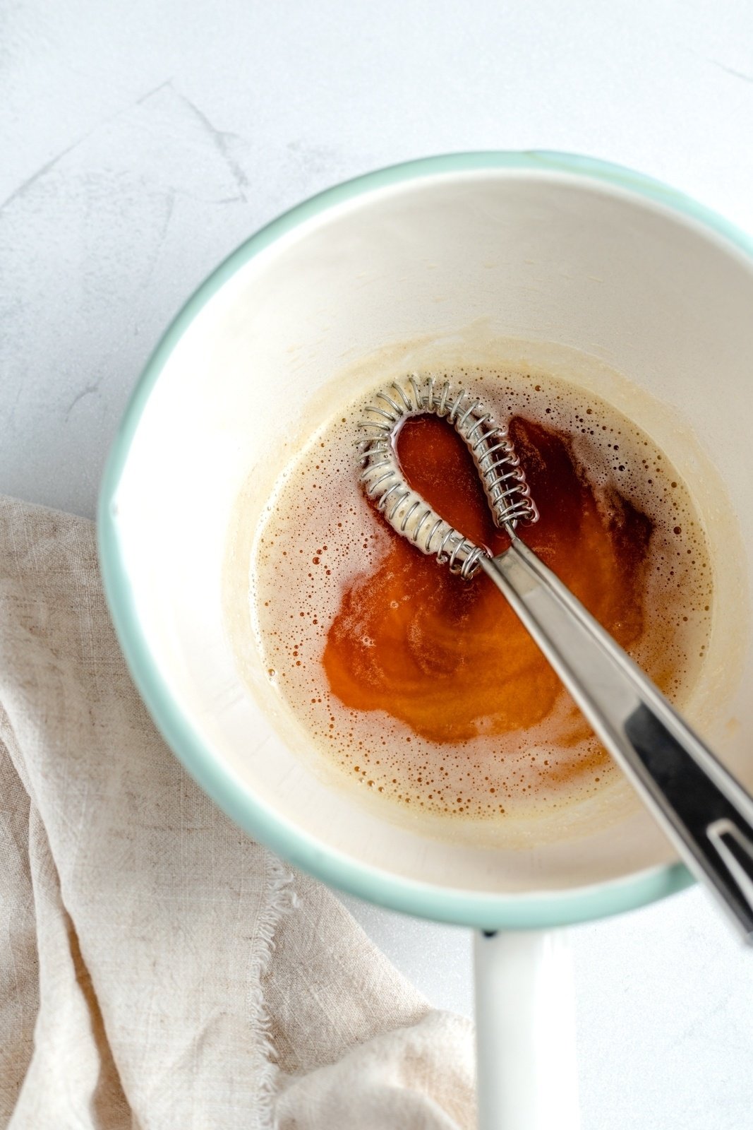browning butter in a saucepan with a whisk