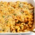 pumpkin mac and cheese in a casserole dish with a spoon